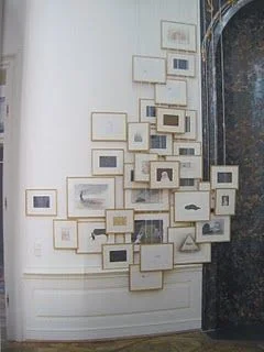 Simple black and white artwork layered on top of each other creates such drama! I also like the way they chose to install this on a wall that is curved, a spot that is often difficult to make look finished, now looks fabulous and unexpected.