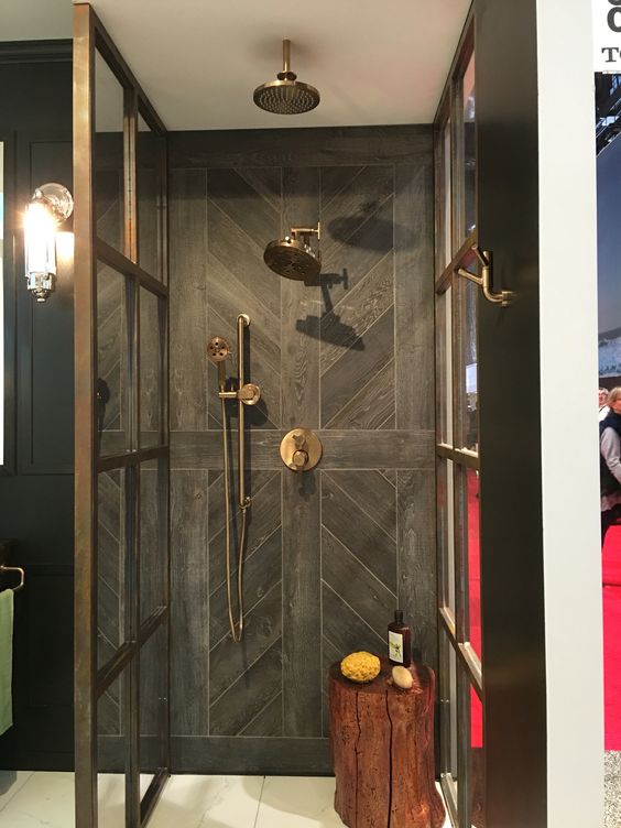The tile installation on the back wall of this shower. Simple hardwood floor look alike tile is taken to another level just with the installation.