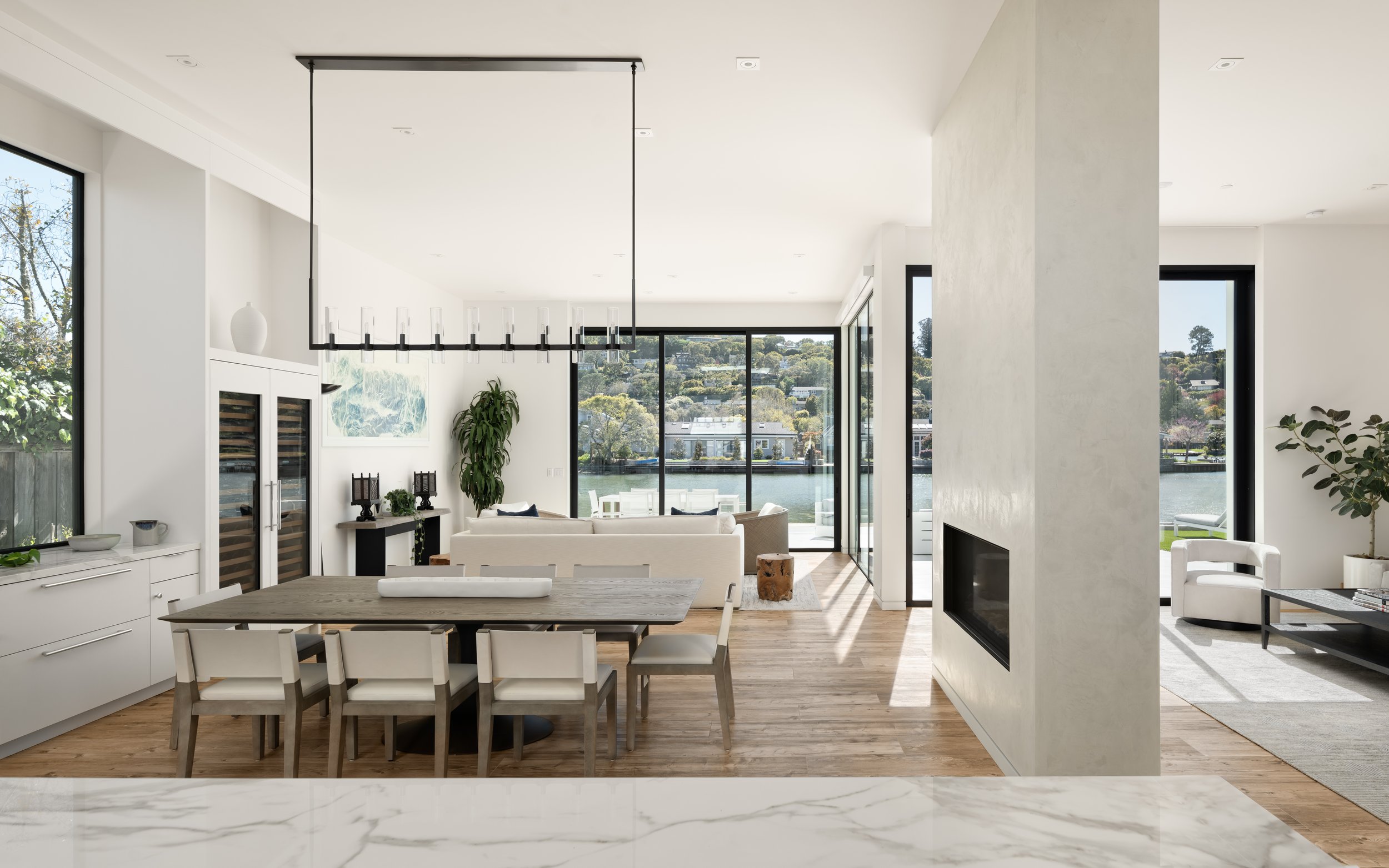  The interior space borrows light from the sides through large cross-sectional windows while the house spatially opens to the rear toward the lagoon. This combination of light and space, of primary and secondary cross axes, produces a home that is sp