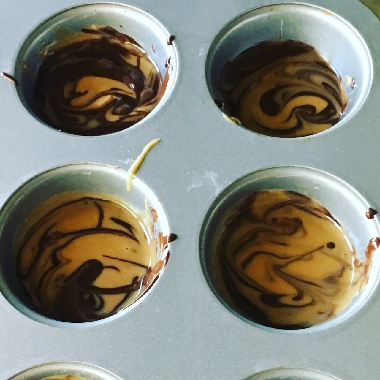 If you spray your mini muffin tin with cooking spray first, popping the PB cups out of the tin will be much easier.