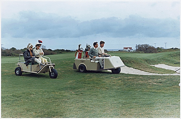President John Kennedy and Washington Post editor Ben Bradlee enjoy a round of golf at Newport while Jackie Kennedy and Jean Bradlee look on.