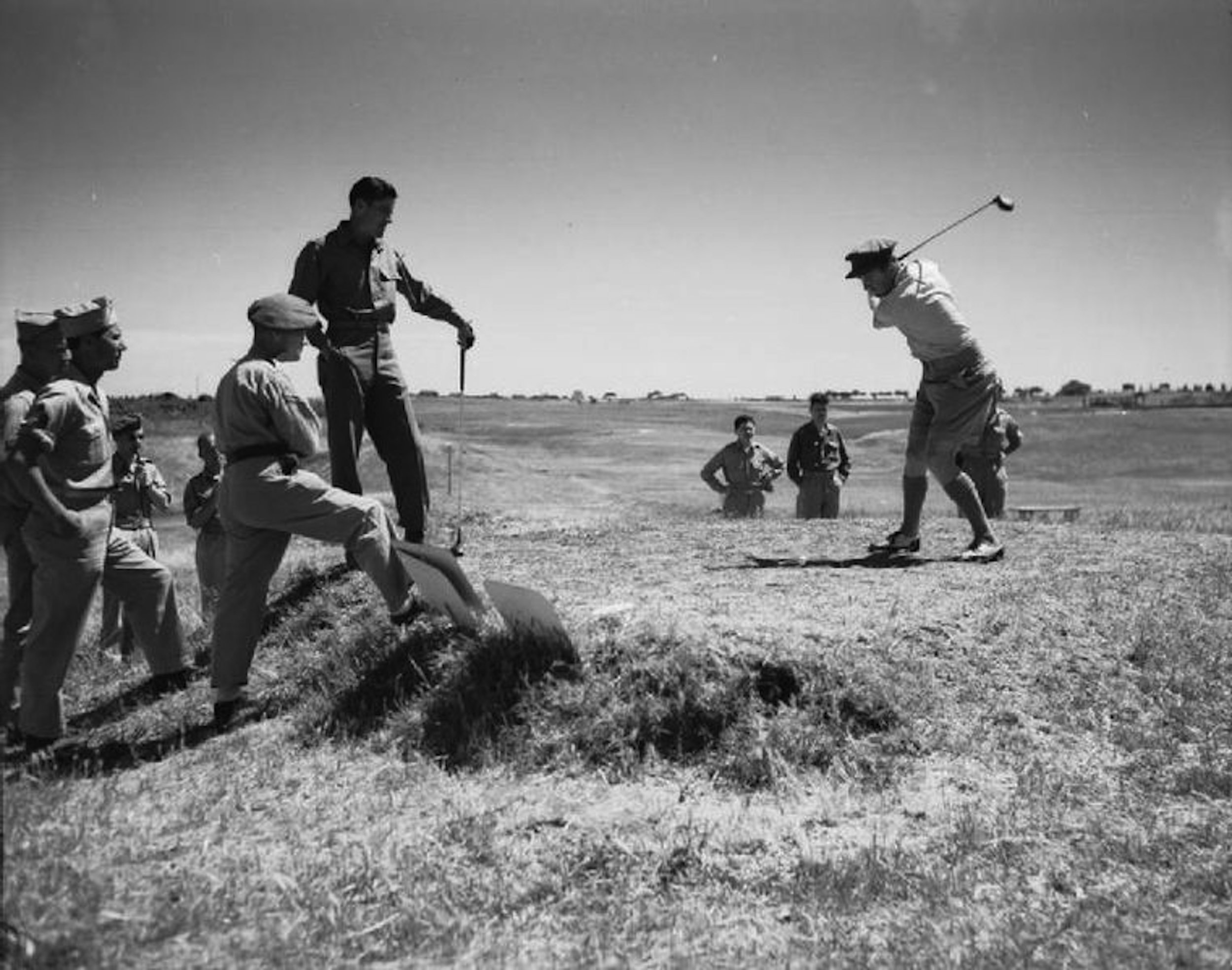 Private Tommy Bolt watches Lieutenant Bobby Locke go after a drive in a Services Golf Tournament in rome. In the post-World War II years Bolt would win a U.S. Open and the first ever Rubber City Open at Firestone; Locke would capture four British Open championships.