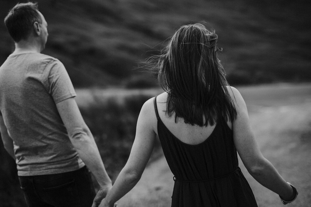  dark hair woman walking on the road with a man in t-shirt 