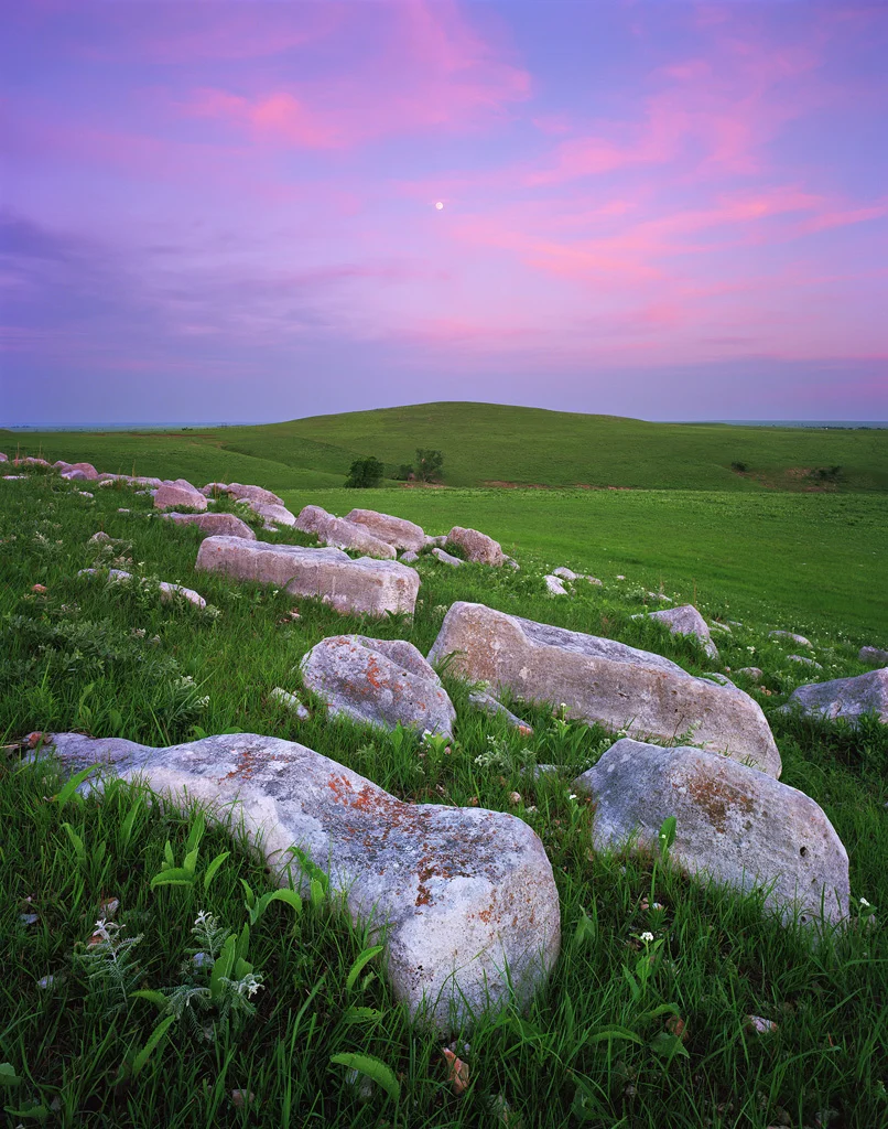 "Flint Hills Moonrise" - The moon rises over the namesake stones of the Flint Hills at sunset. These large outcroppings dot the rich green landscape of rolling grasslands. Prints Available.