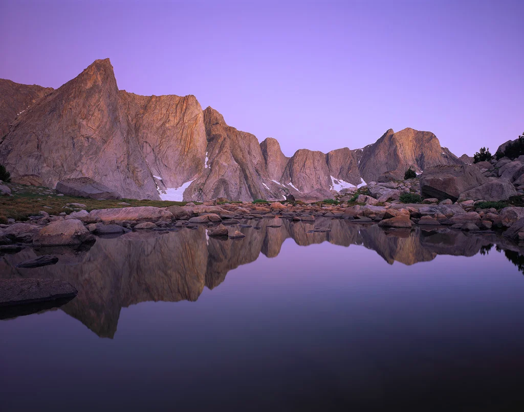 "Twilight Reflections" - Rock spires rise thousands of feet over a calm reflecting pond deep in the Wind River Range of Wyoming. Prints available.