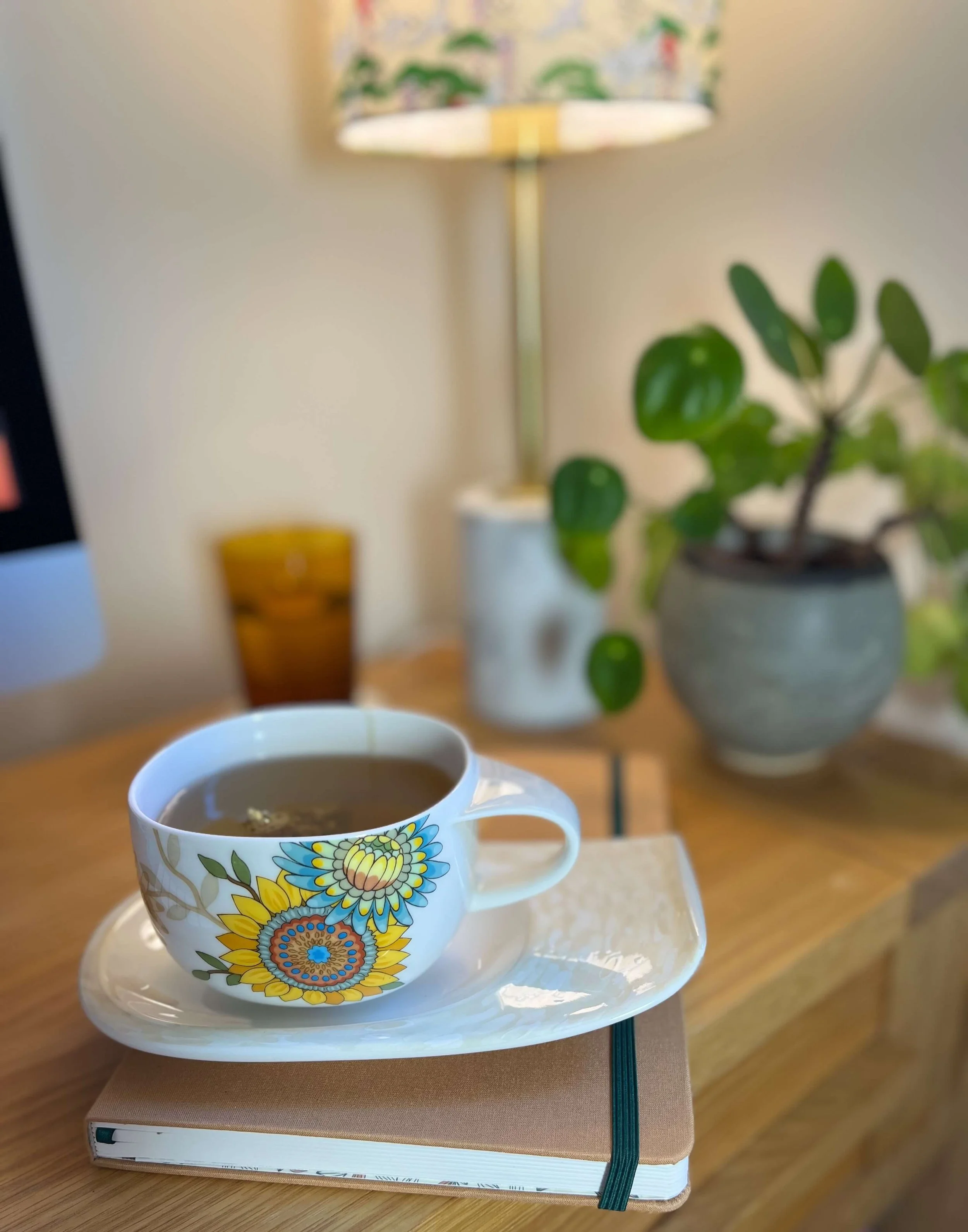 A warm and welcoming therapy setting with a cup of tea, books and plants — a safe space for gambling addiction counselling
