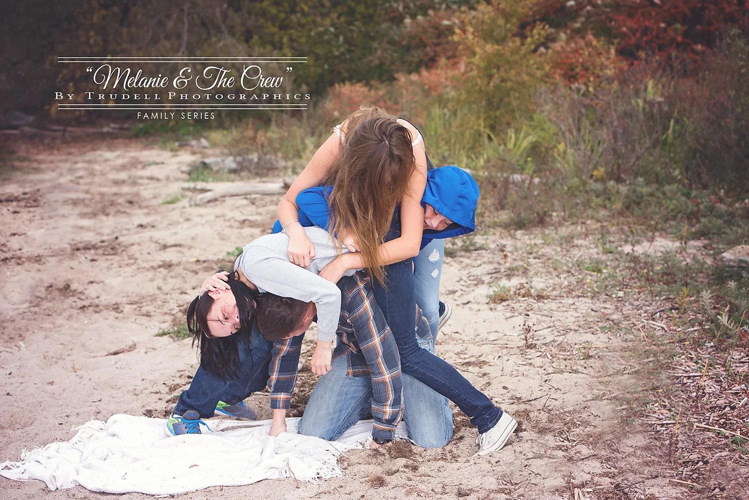 There are FOUR people....count them, 1, 2, 3, 4 people in this little ball in the sand.