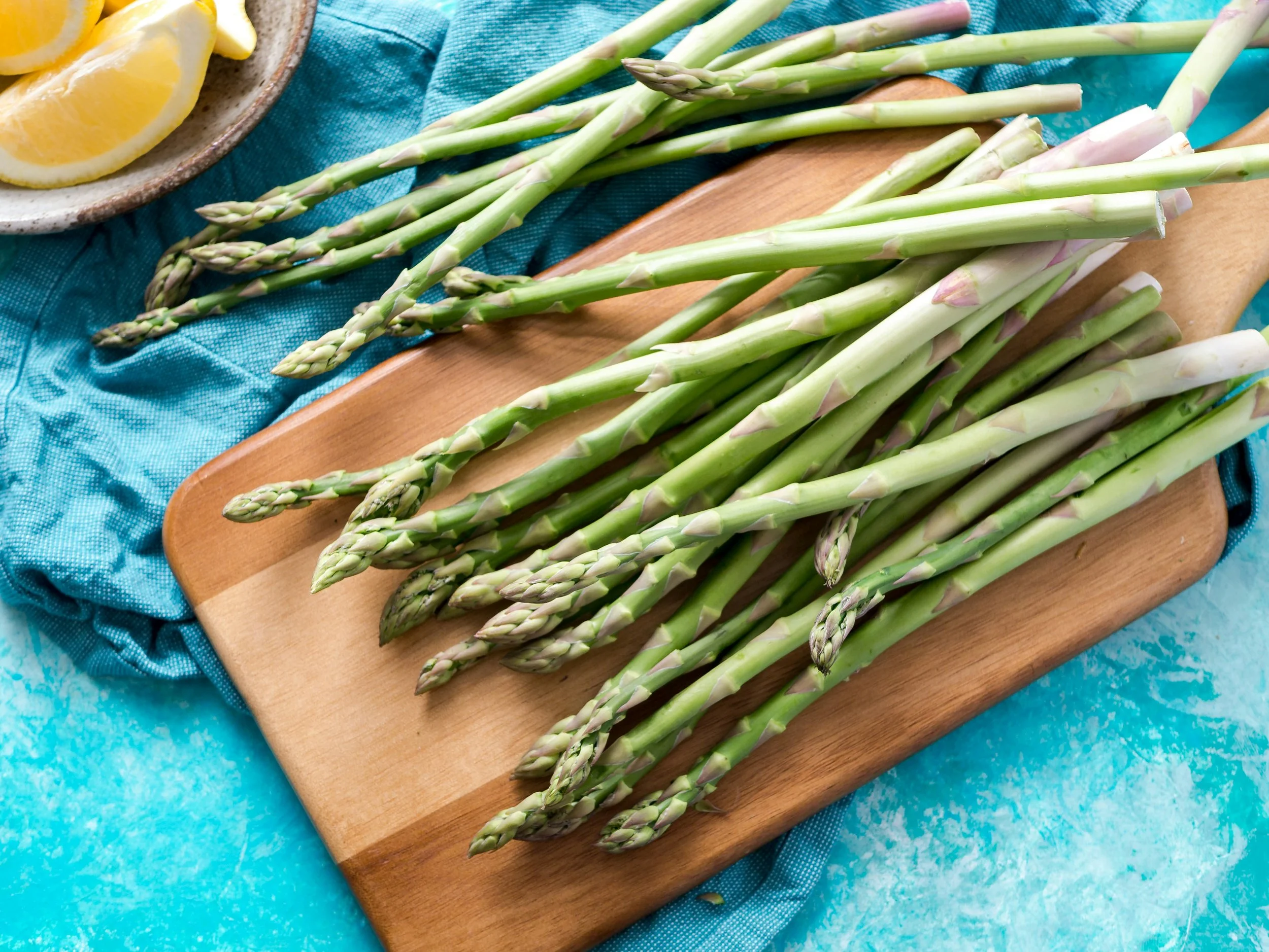 Fresh asparagus on cutting board