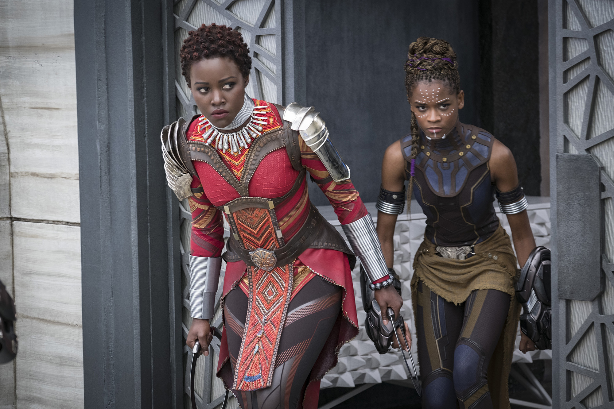 Nakia (Lupita Nyong'o), left, and Shuri (Letitia Wright). "Black Panther" follows conventions of action movies but also enlarges and revitalizes them. MUST CREDIT: Matt Kennedy, Marvel Studios-Walt Disney