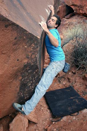 Andrew Bisharat pooping on a boulder. Photo courtesy of google search and Rock and Ice.