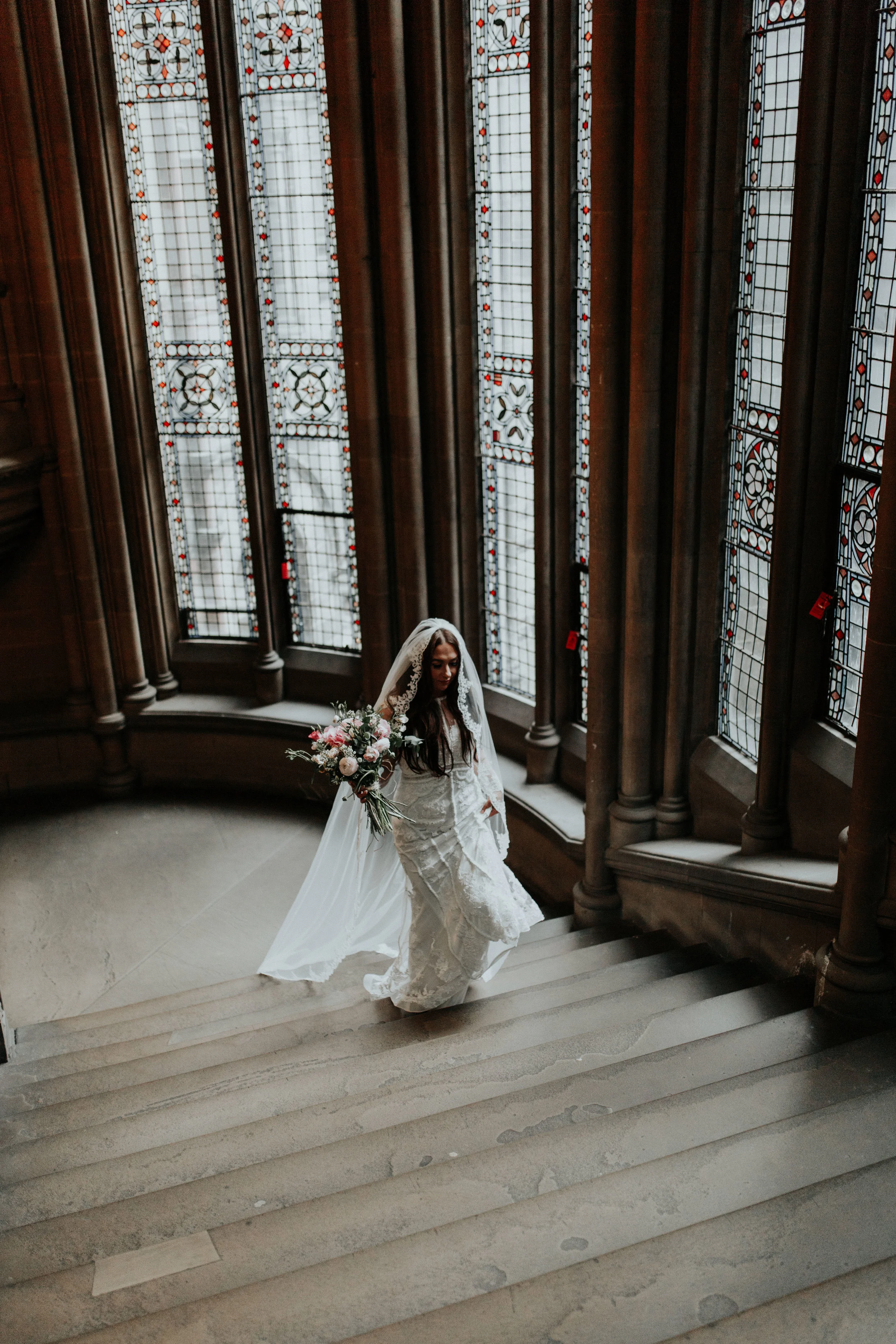 Bride walking up the stairs at Manchester Town Hall