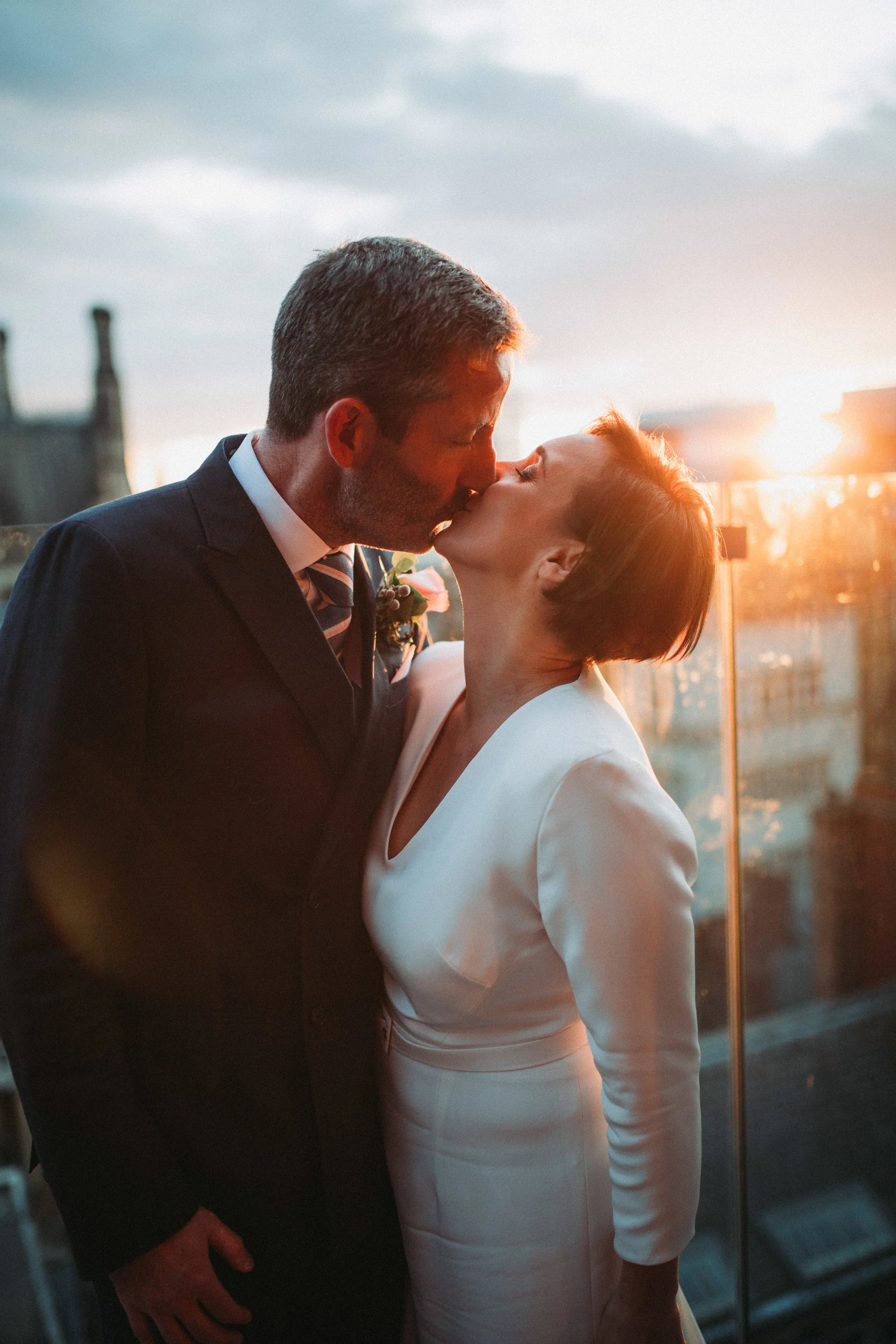 Bride and groom kissing during sunset King Street Town House wedding photographer
