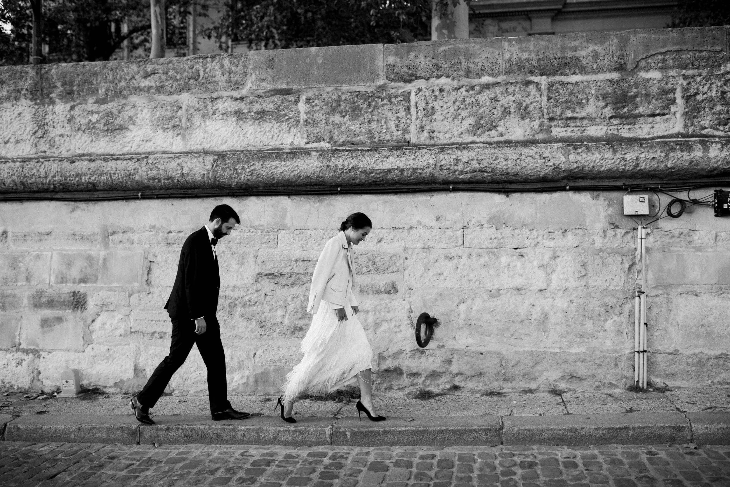 Bride and groom walking through Paris