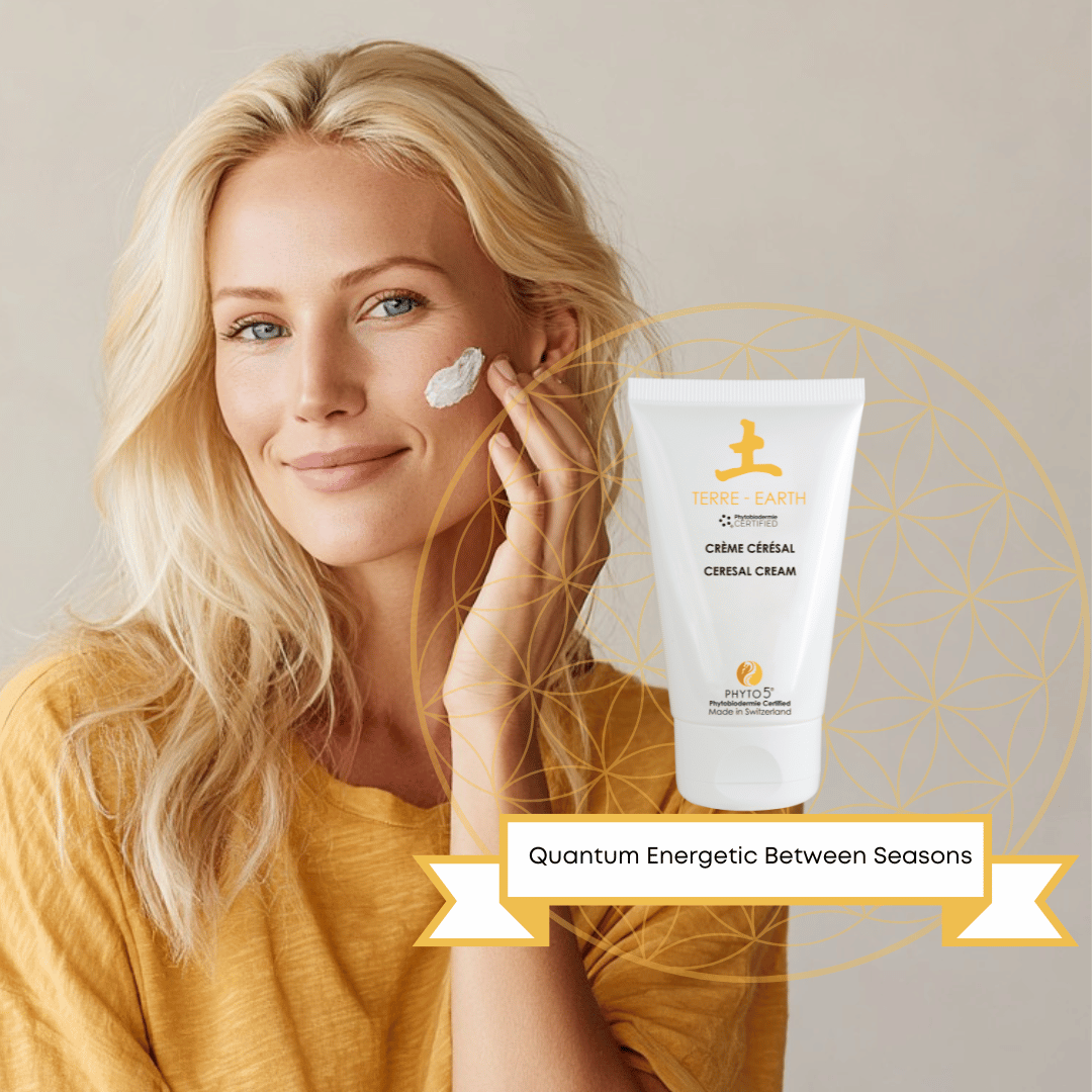 A blonde woman applies a dollop of Earth element Face Cream to her face