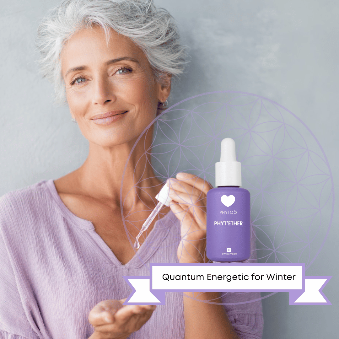 A mature woman dispenses a solitary drop of Water element Phyt'Ether serum into the palm of her hand