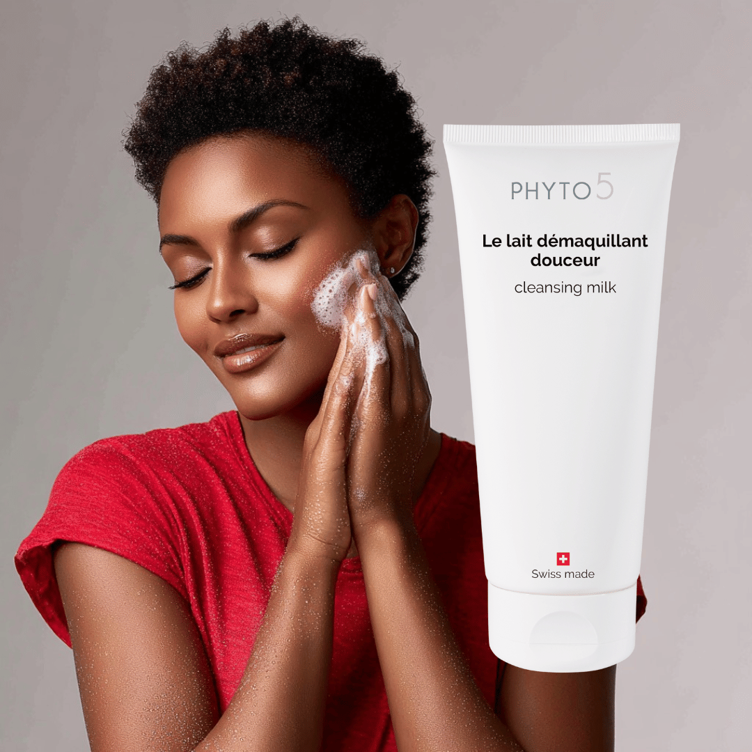 An African American woman washes her face with Cleansing Milk