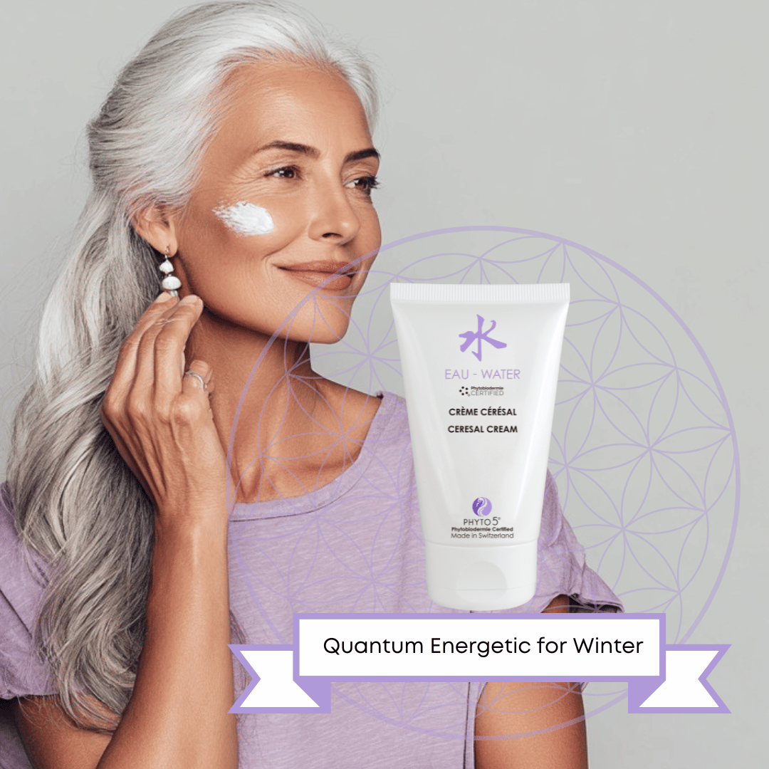 A mature woman smears a dollop of Water element Day Cream to her cheek