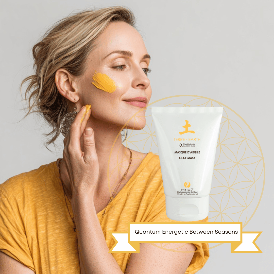 A blonde woman demonstrating Earth yellow Clay Mask on her face
