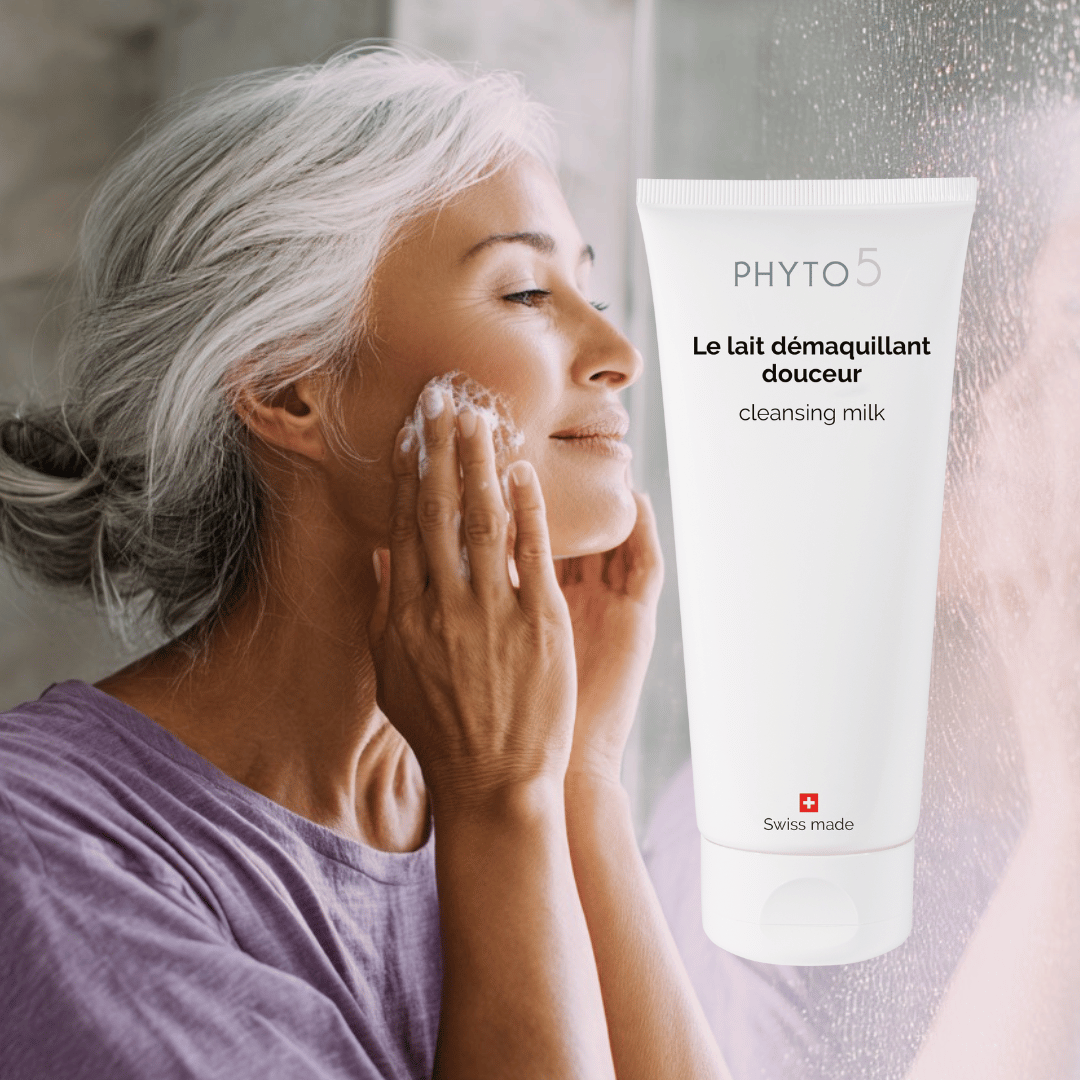 A mature woman washes her face with Cleansing Milk