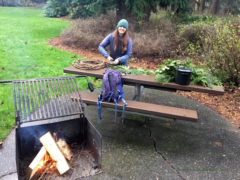 Melissa getting the wreath making materials ready for the soon to be arriving families while the fire burns...