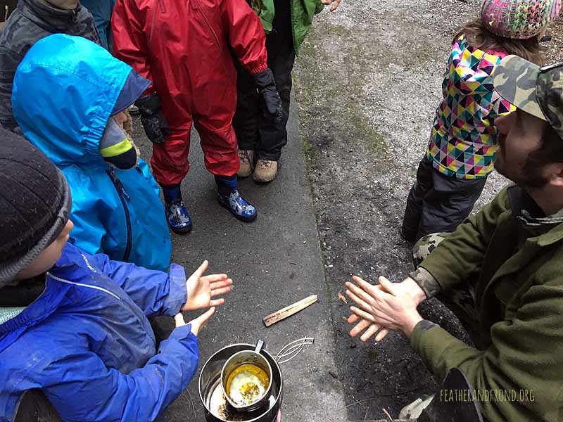 Double boiling the oil and beeswax over the fire