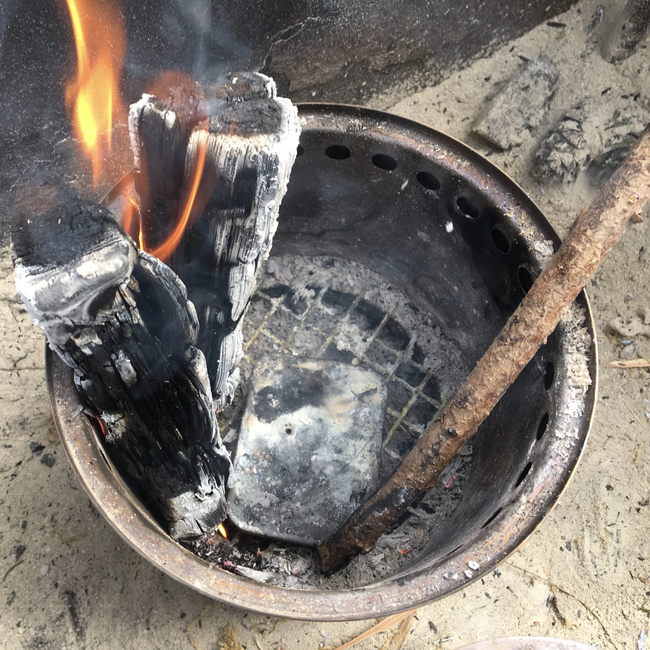 Cooking Char Cloth in a fire can