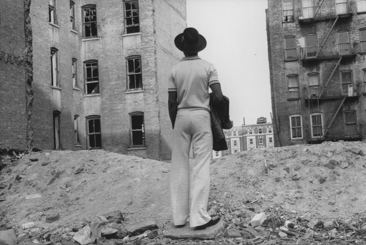 Pearl standing in a lot behind two buildings in the South Bronx.