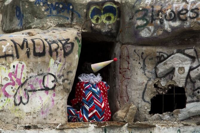  Lauren Steinberg,  The Clown at Terrible Times . Performance with vintage costume, water balloons, rubber slingshot, and other found and handmade objects. 