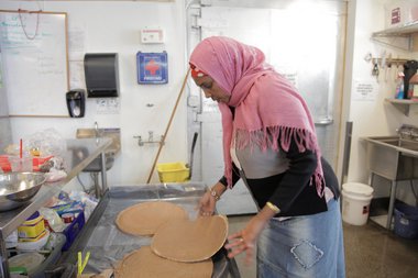 Asha Gebibo, 64, makes injera every other day at the Village Market in New Columbia. Casey Parks/The Oregonian