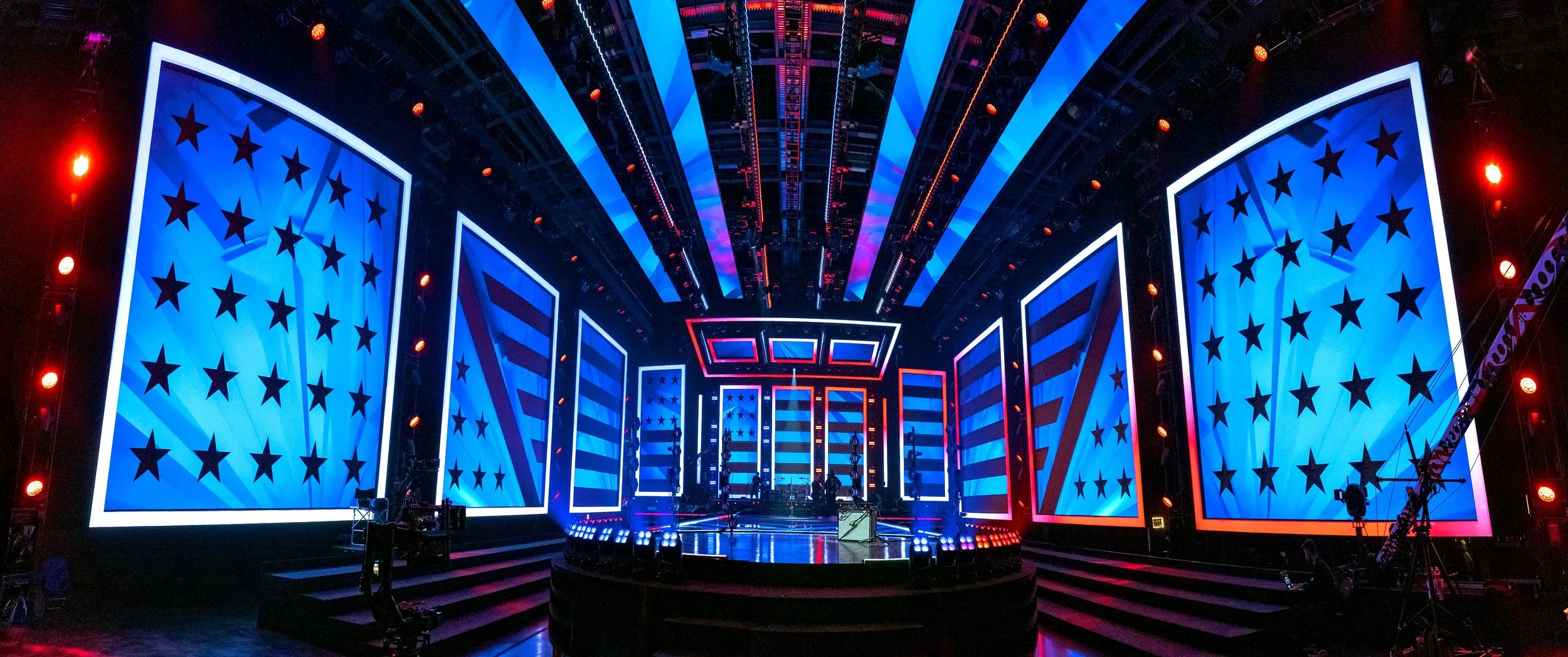 Stage decorated with American flag-themed screens and lighting, ready for a political or patriotic event.