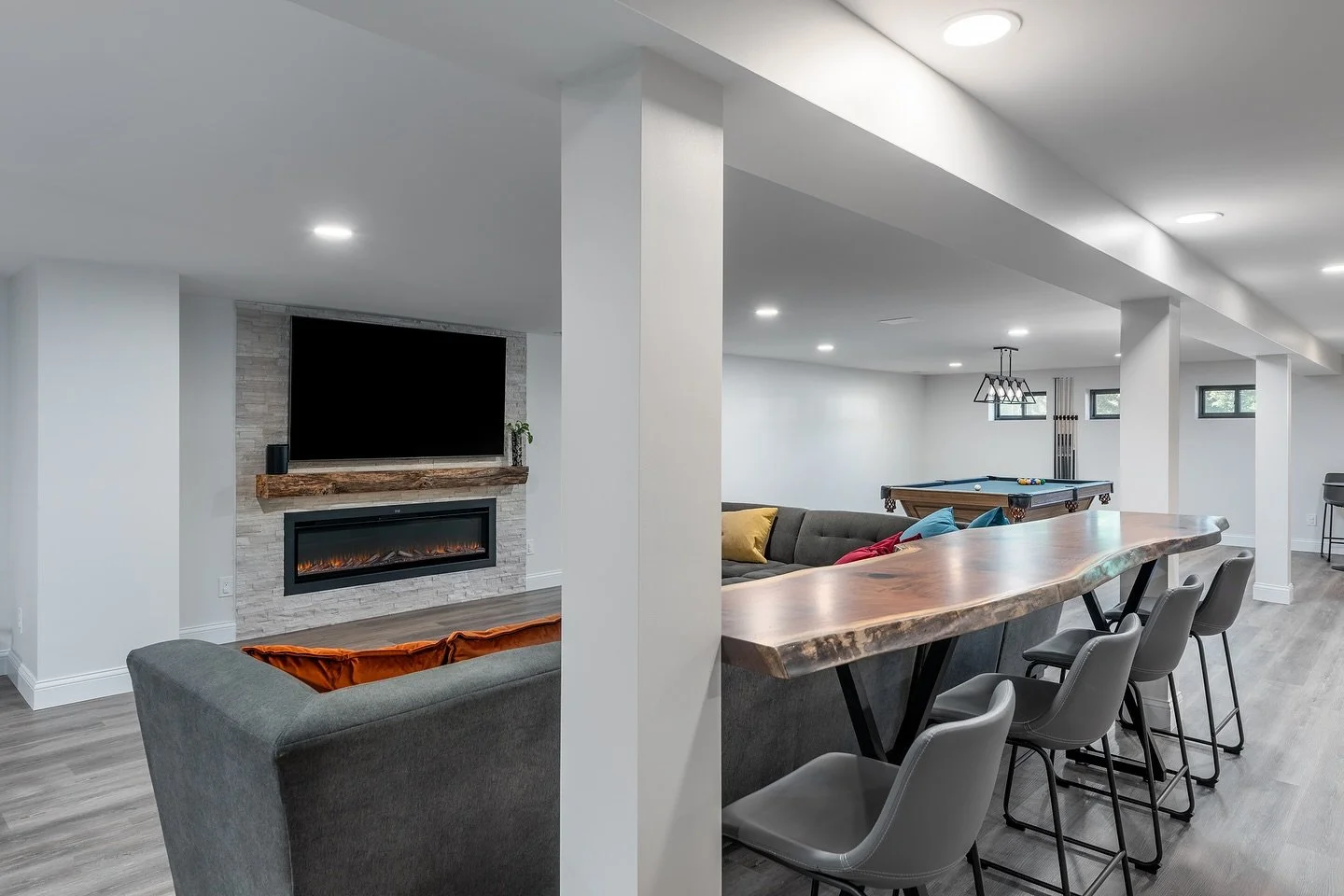 Game nights, movie marathons, and everything in between 🎱🔥
This finished basement was designed for comfort and connection &mdash; complete with a custom live-edge bar, electric fireplace, and entertainment area ready for family and friends.

#Basem