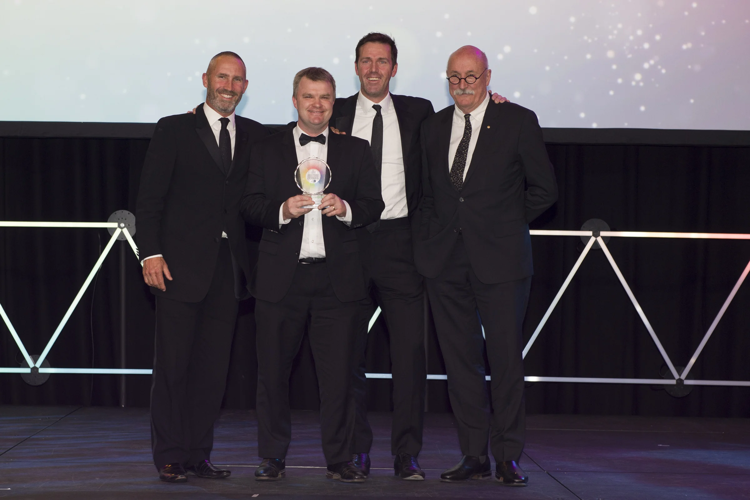 (From left to right) James Robinson, John Leo and Adam Somerville accepting a Property Council of Australia award from Bob Nation (GHD Woodhead, Award Sponsor)