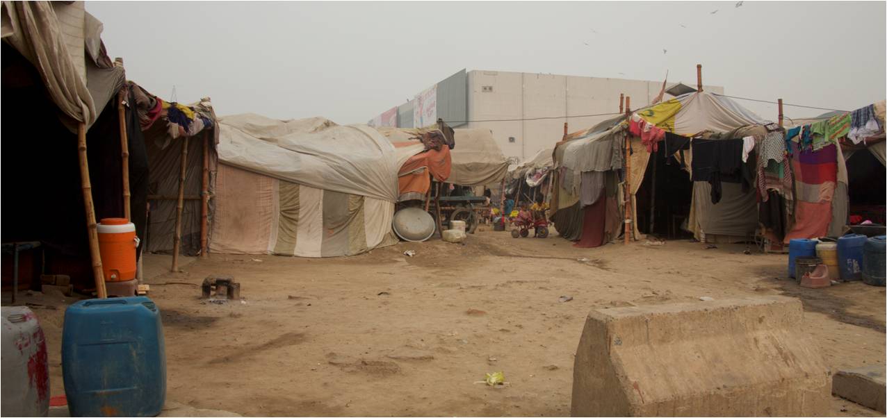 This is a homeless camp for citizens without homes. These are not complete structures; just sticks covered by old sheets with nothing protecting them from the elements.