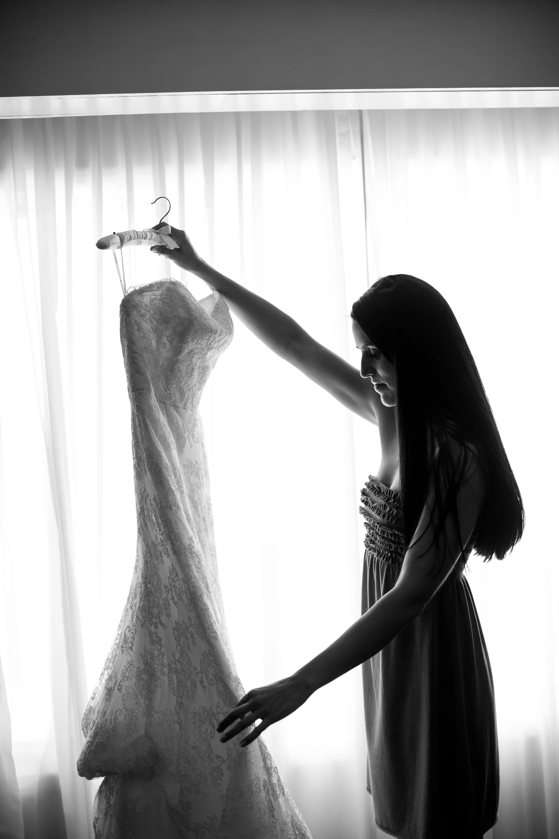 bride holding wedding dress