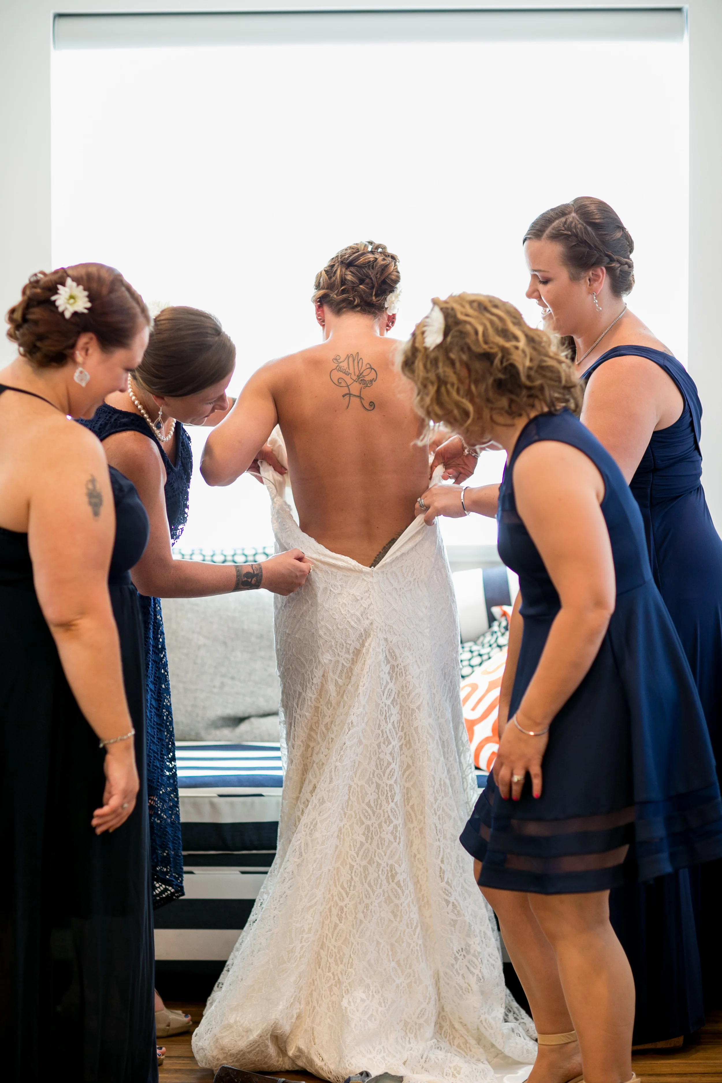 tattooed Bride getting in wedding Dress