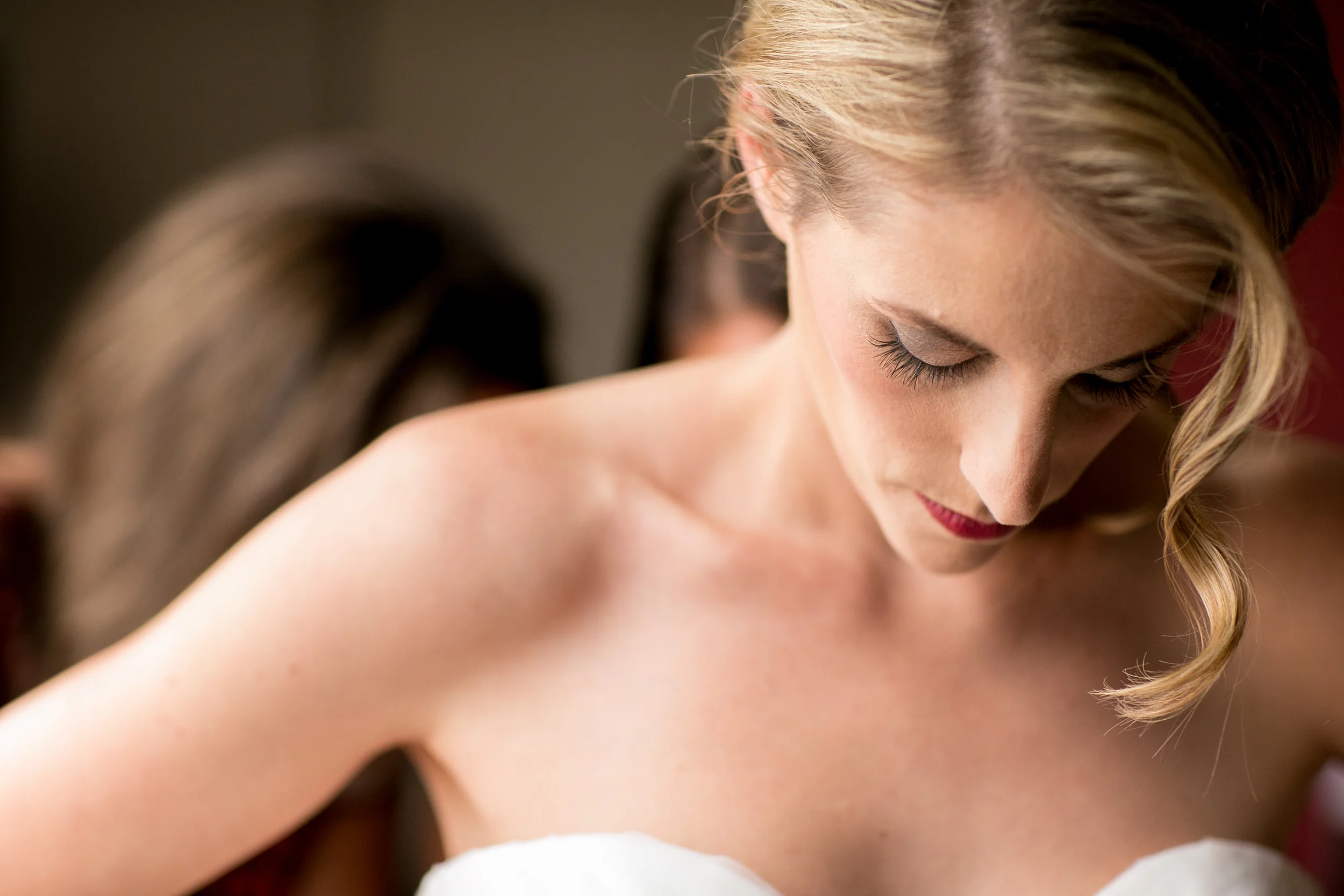 Bride getting wedding dress laced up