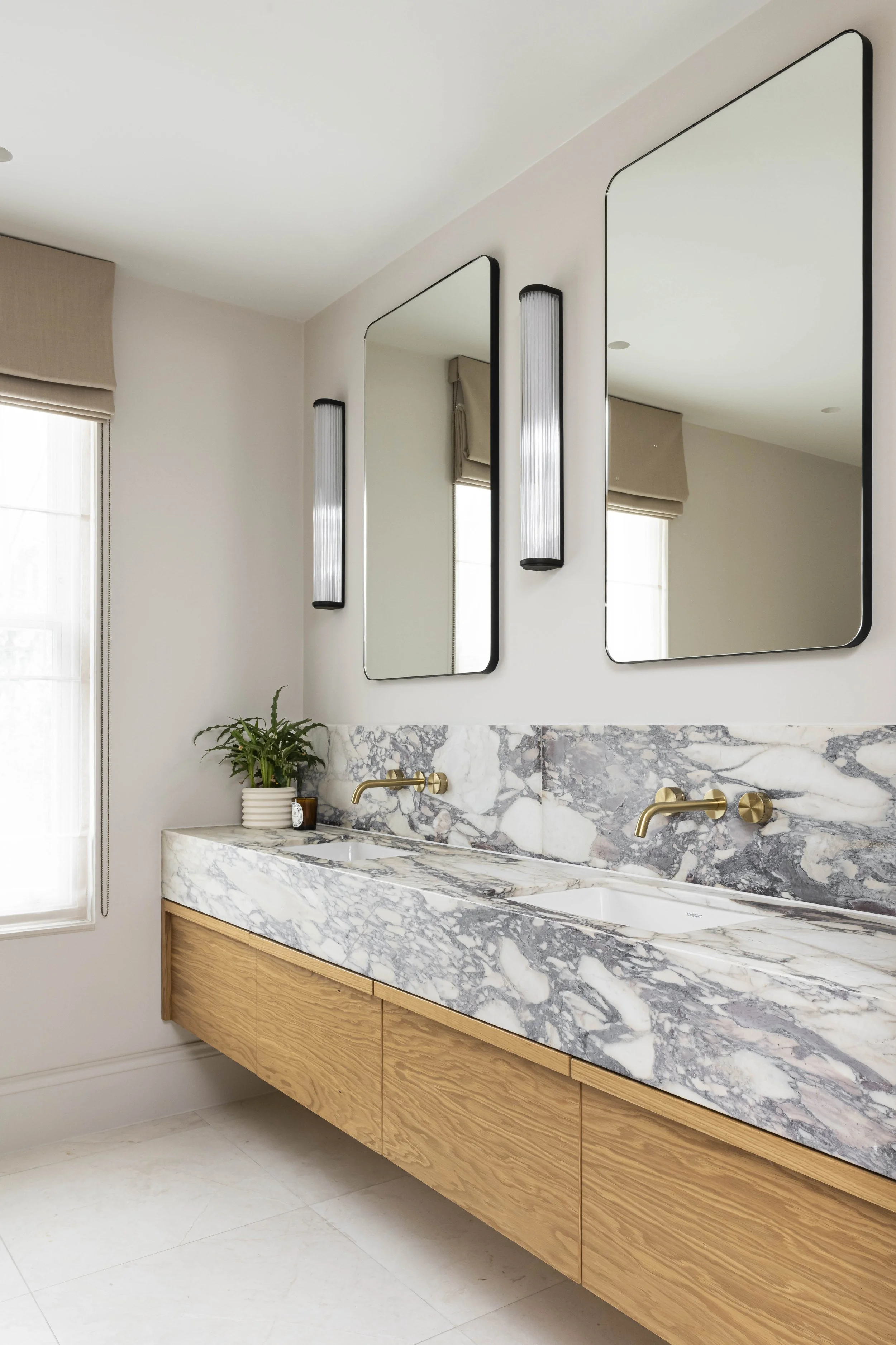 Bespoke marble vanity unit with double sinks in a Victorian house refurbishment by Studio Zeal