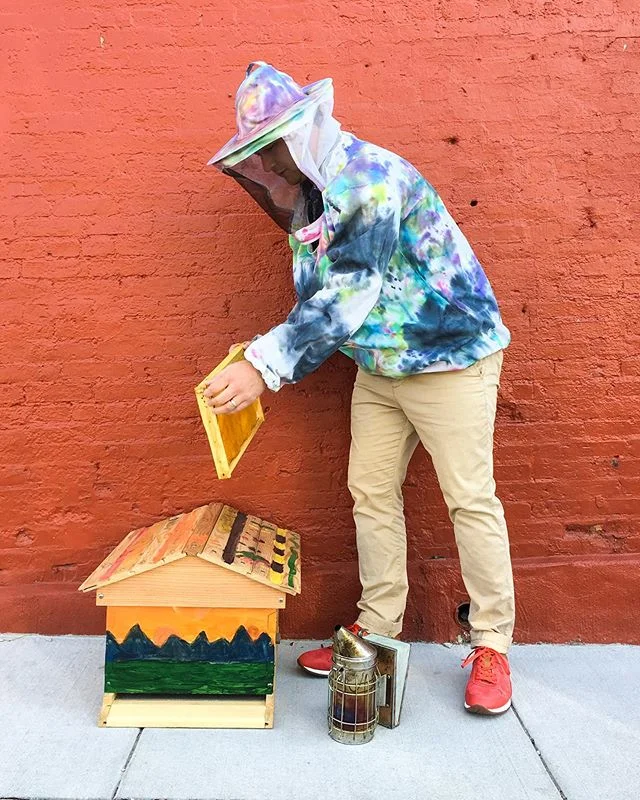 Jordan leads our E-commerce team. When he isn’t crunching those numbers from our website he is an urban bee farmer. Tie-dye and hand painted beehives are custom done by his kids. He is wearing the TS Field sneaker. Perfect for his colorful bee