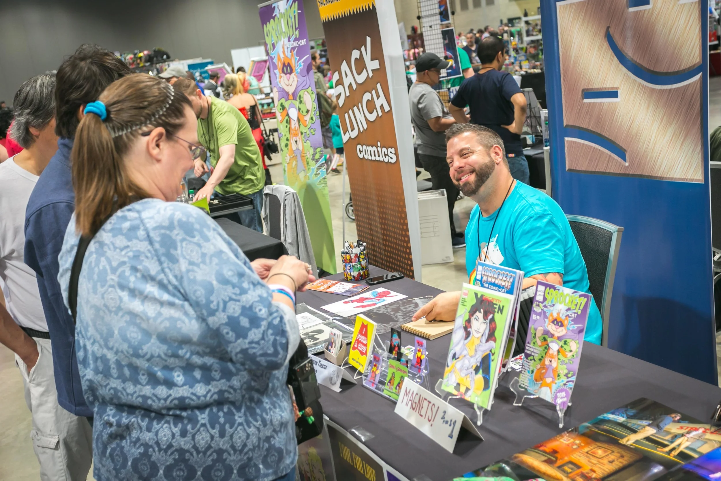 Jeremy works on a piece of commissioned art for a Comicon patron.