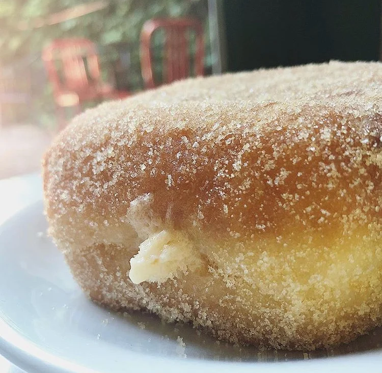 Boxy Brown - A square Bismarck filled with our rich brown-butter cream filling, rolled in toasted sugar.