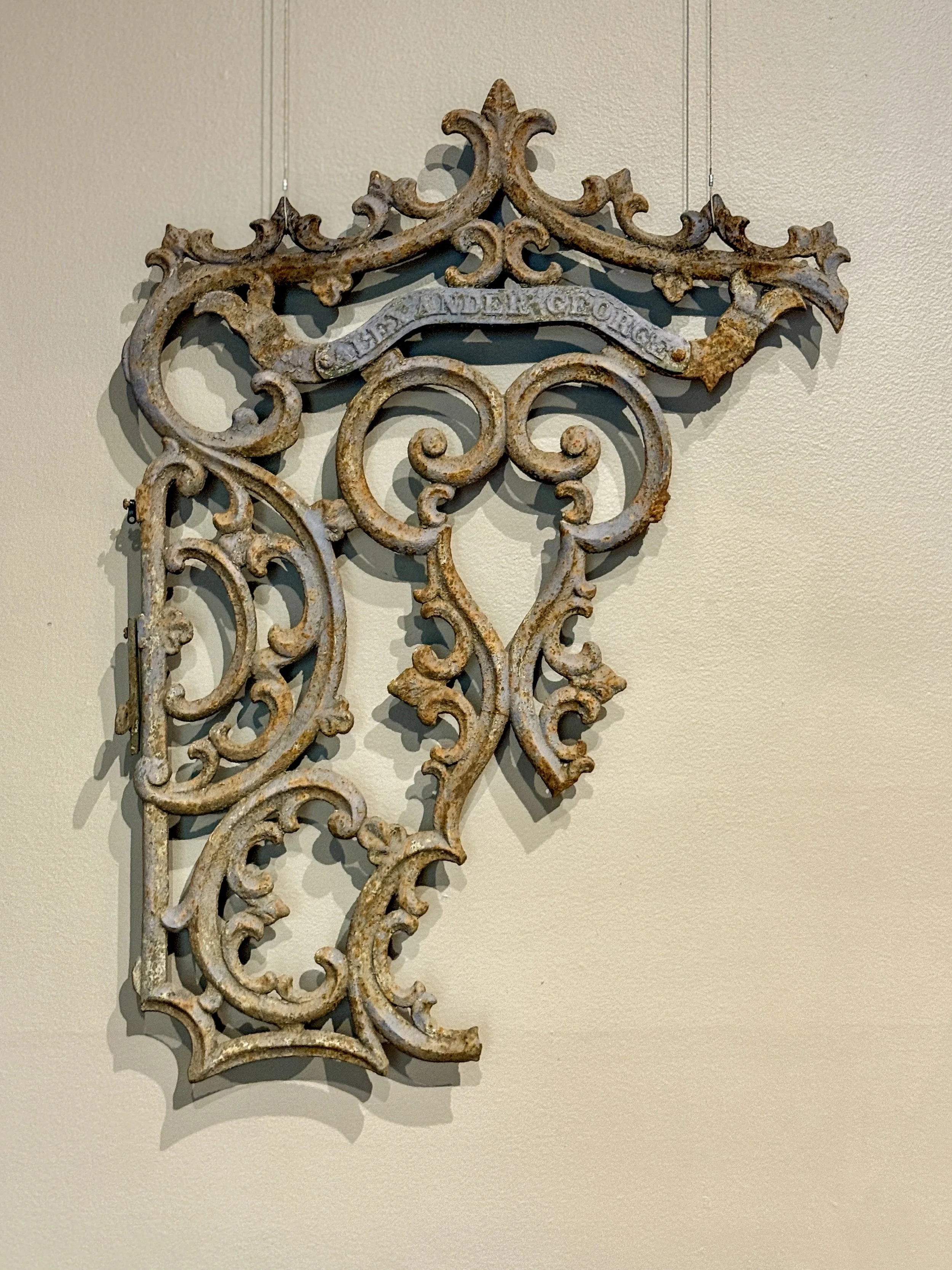 An iron gate fragment from Bonaventure Cemetery hangs on the wall at Telfair Academy in Savannah, Georgia