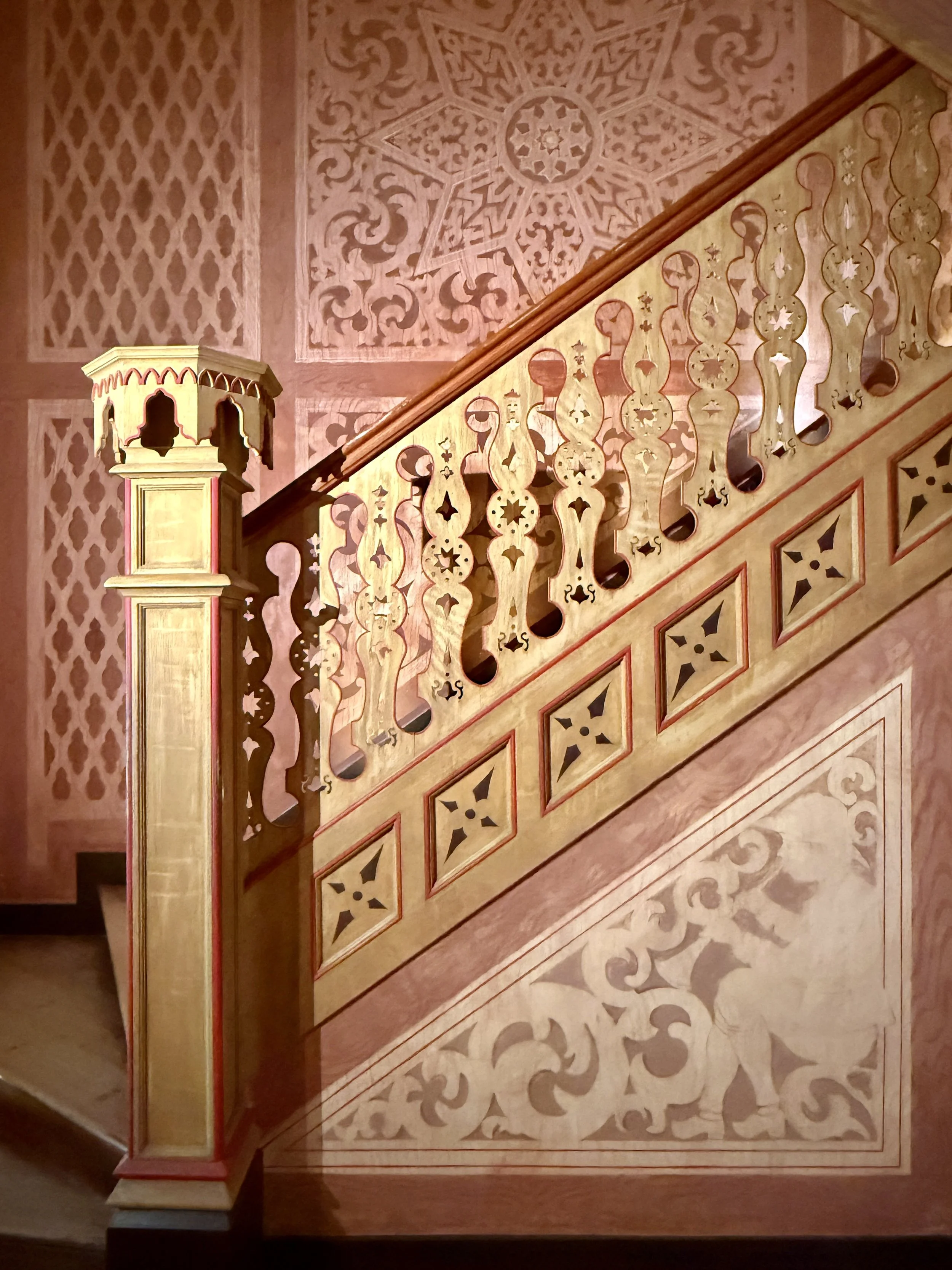 The Romanic staircase with ornate cut-outs and detailed wall at the Chalet da Condessa d’Edla in Sintra, Portugal