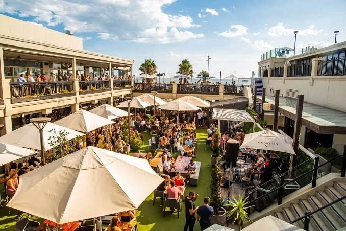 Diners eat under umbrellas at Republica St Kilda Beach