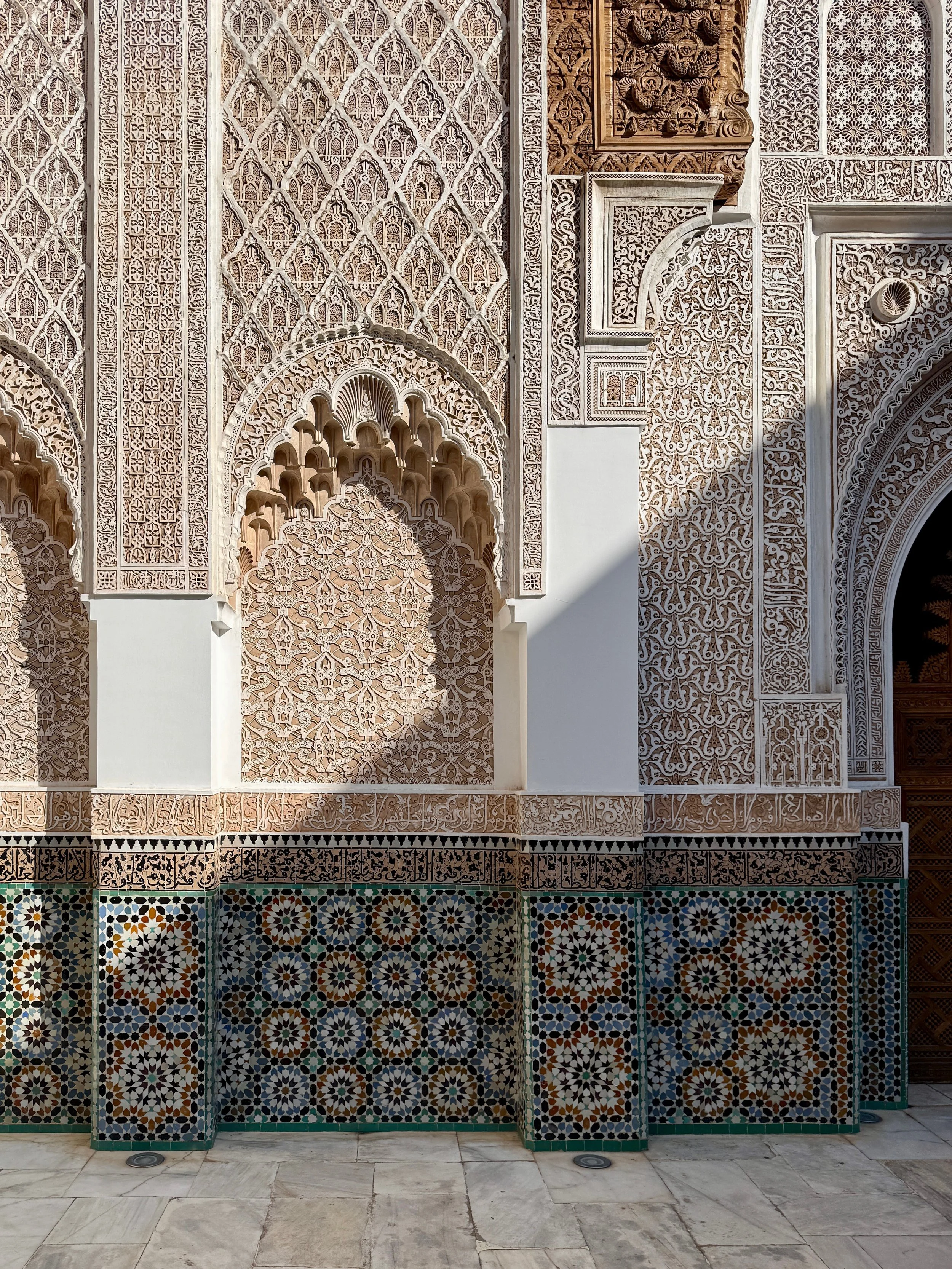 Ornate carvings and tilework at Ben Youssef Madrasa