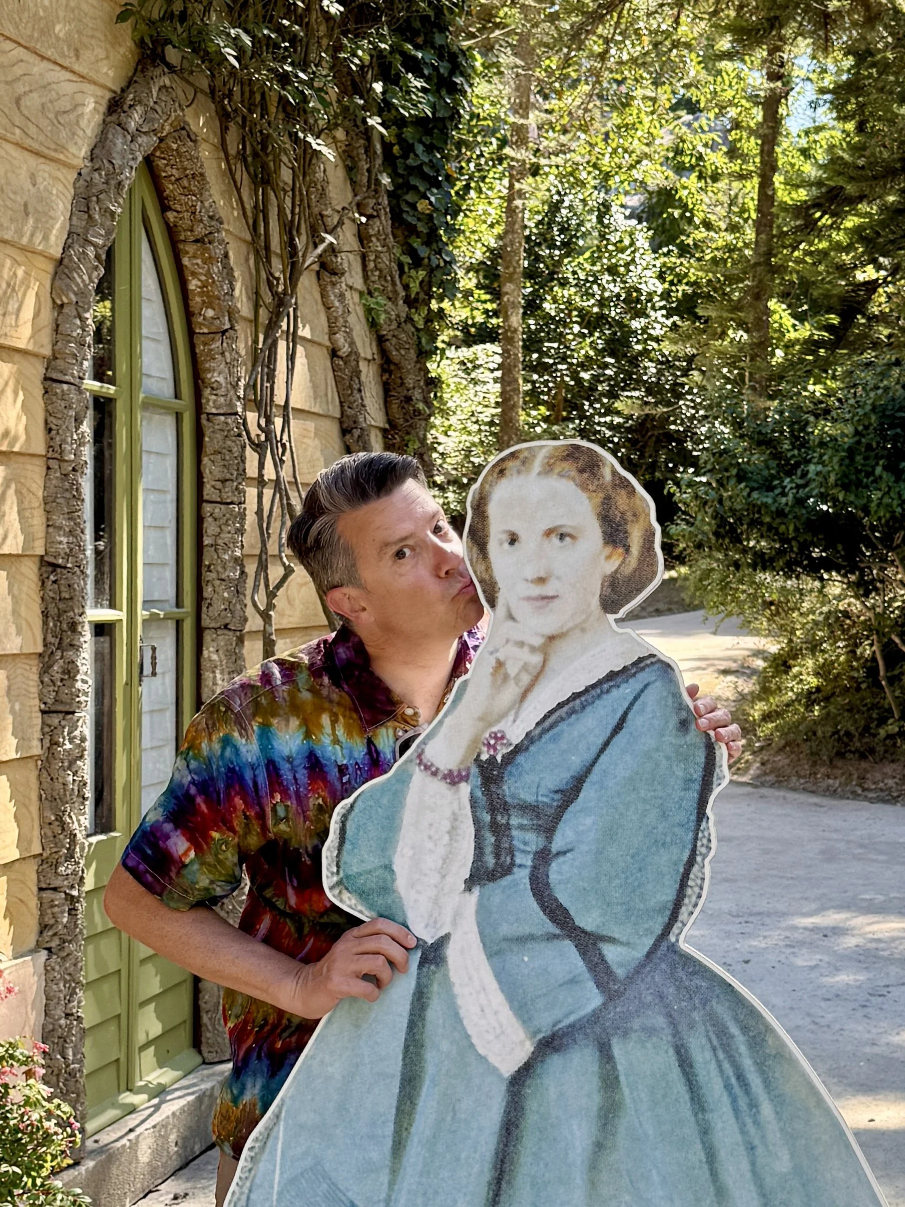 A man in tie-dyed shirt kisses a cutout of the Contessa d'Edla at he chalet in the Park of Sintra in Portugal