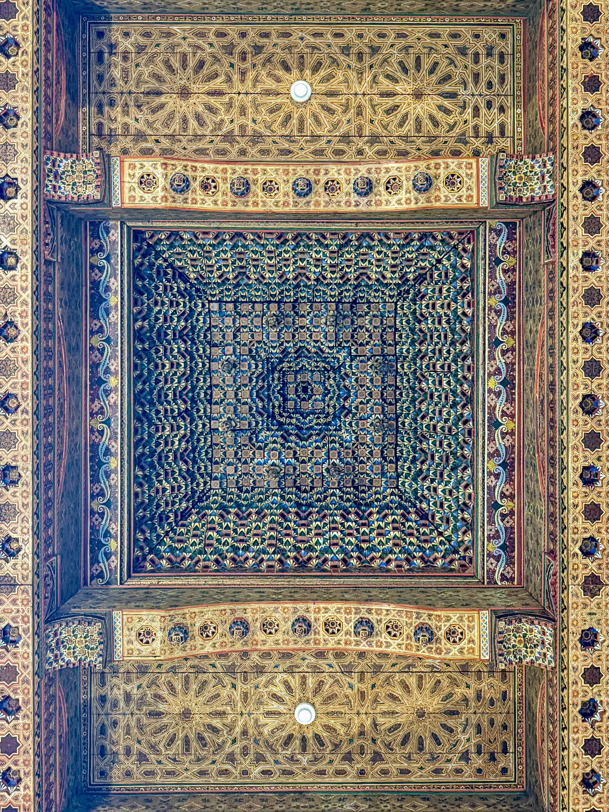 Colorful, kaleidoscopic carved and painted wood ceiling at Dar el Bacha, Marrakech, Morocco