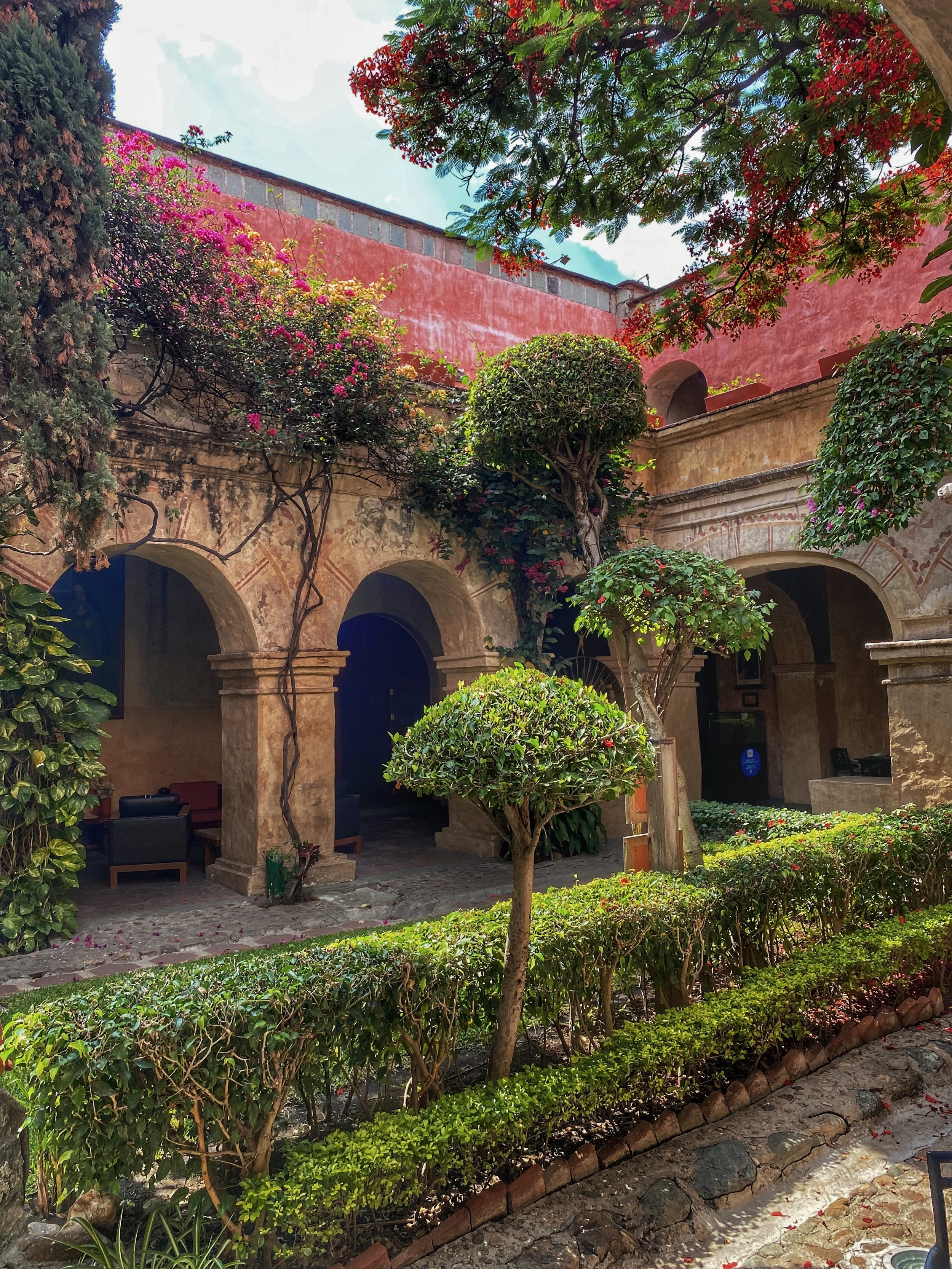 Interior colonnade with hedge and trees at the Quinta Real hotel in Oaxaca, Mexico