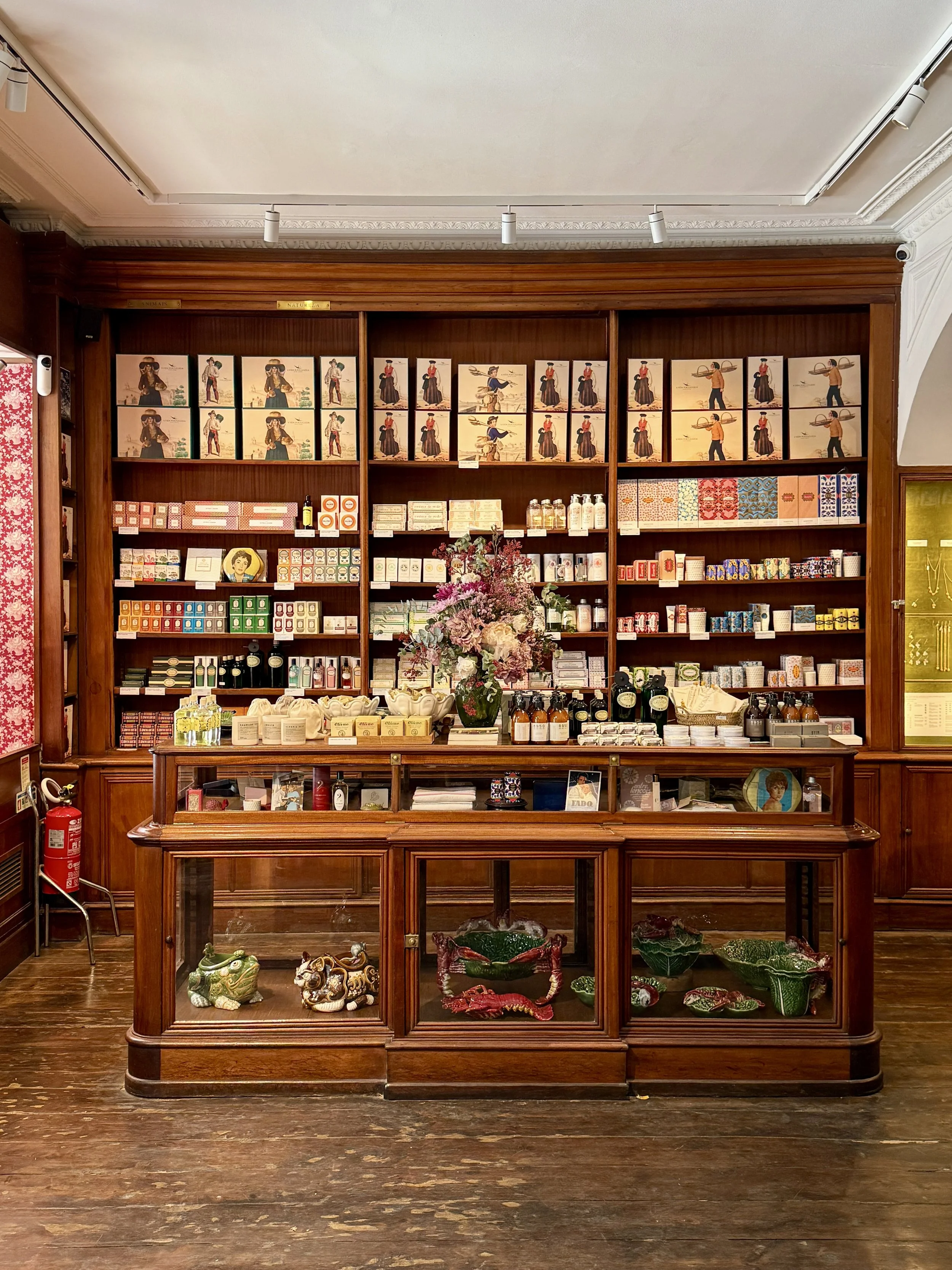 A Vida Portuguesa’s flagship location occupies the former Livraria Férin, Lisbon’s second-oldest bookshop, preserving its original wooden display cases and cabinetry.