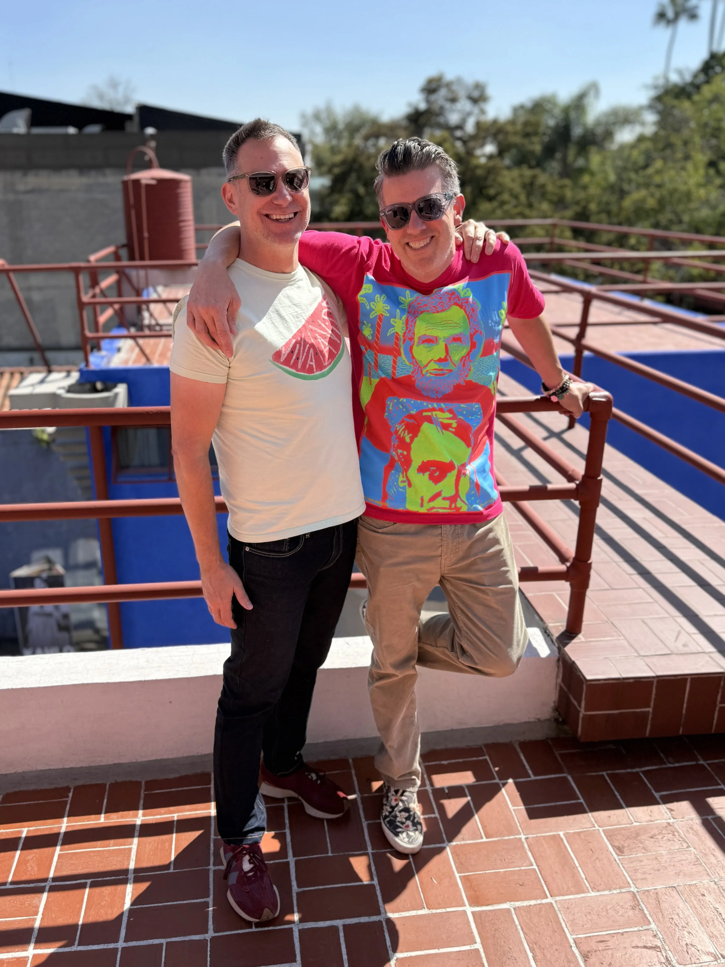 Duke and Wall stand on the rooftop terrace of Diego's house and the walkway that leads to Frida's