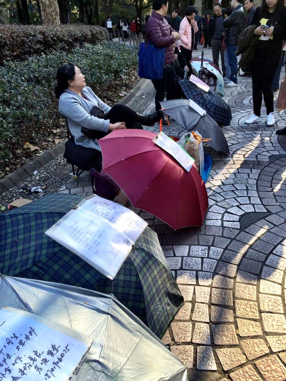  Parents sit in the park advertising for husbands or wives for their kids 
